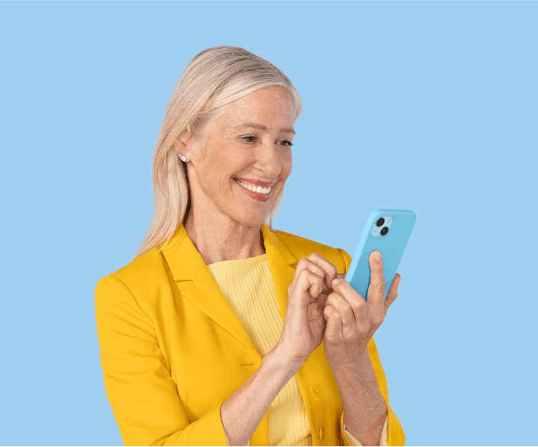 A woman smiling using her cell phone