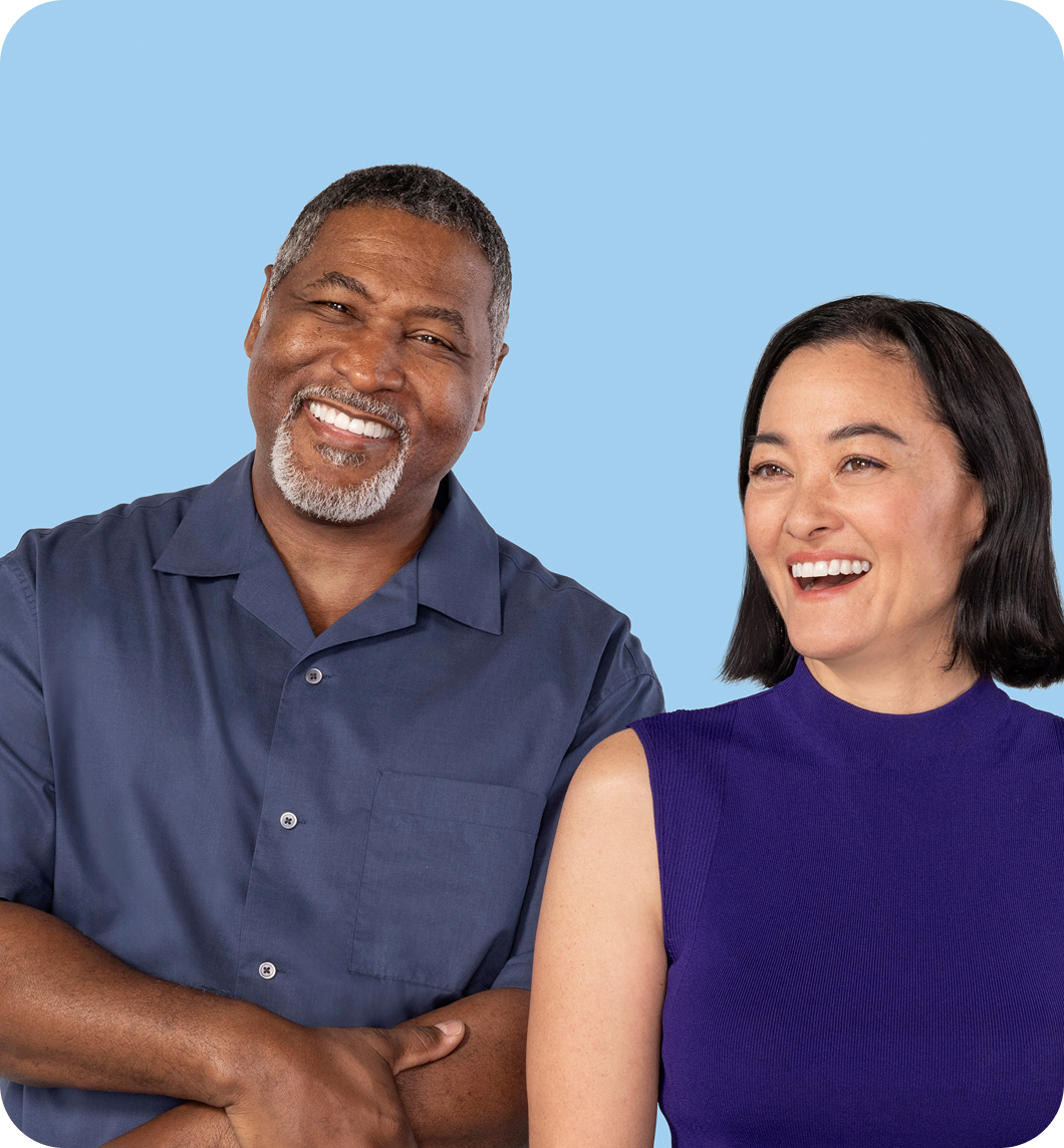 Man and woman standing next to each other smiling